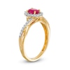 Oval Ruby and 0.20 CT. T.W. Diamond Frame Twisted Bypass Split Shank Ring in 10K Gold