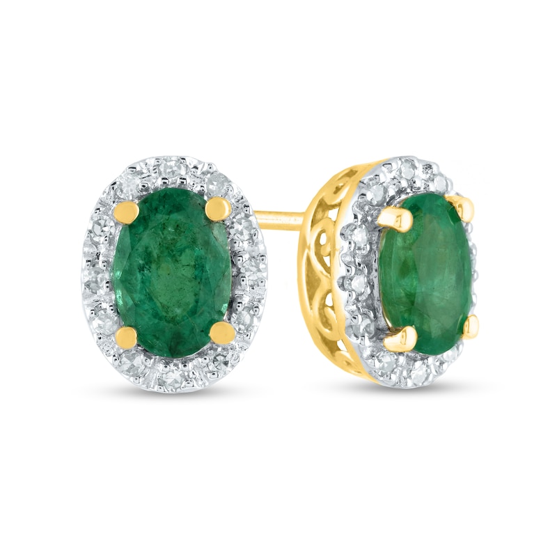 Main Image 1 of Oval Emerald and 0.10 CT. T.W. Diamond Frame Stud Earrings in 14K Gold