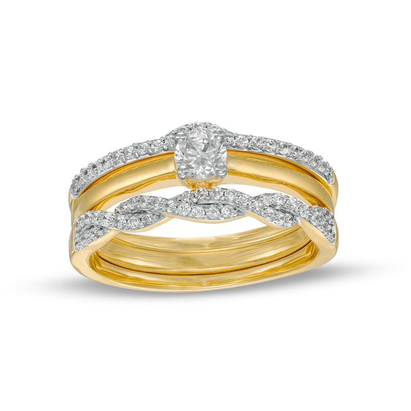 0.45 CT. T.W. Diamond Twist Three Piece Bridal Set in 10K Gold (J/I3)