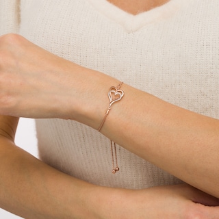 0.088 CT. T.W. Diamond Interlocking Double Elongated Heart Bolo Bracelet in Sterling Silver with 14K Rose Gold Plate