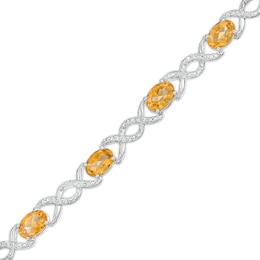 Oval Citrine and 0.18 CT. T.W. Diamond Infinity Ribbon Link Line Bracelet in Sterling Silver – 7.5&quot;