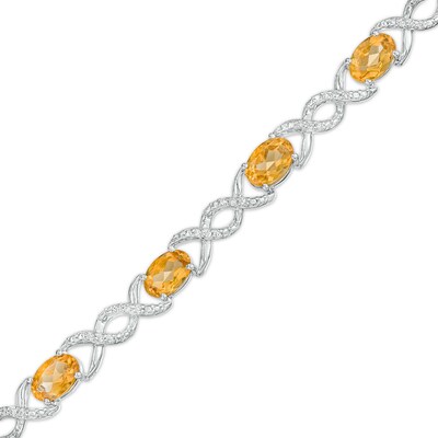 Oval Citrine and 0.18 CT. T.W. Diamond Infinity Ribbon Link Line Bracelet in Sterling Silver – 7.5"