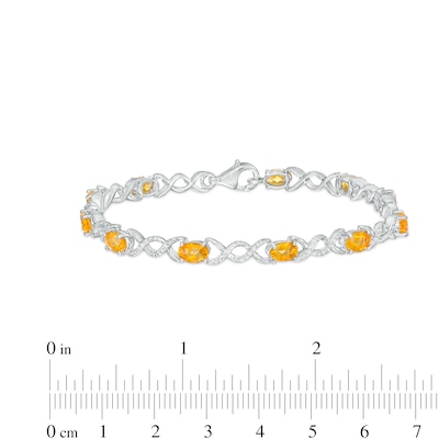 Oval Citrine and 0.18 CT. T.W. Diamond Infinity Ribbon Link Line Bracelet in Sterling Silver – 7.5"