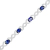 Thumbnail Image 0 of Oval Blue Lab-Created Sapphire and 0.18 CT. T.W. Diamond Infinity Ribbon Link Line Bracelet in Sterling Silver – 7.5"