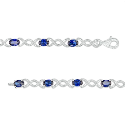 Oval Lab-Created Sapphire and 0.18 CT. T.W. Diamond Infinity Ribbon Link Line Bracelet in Sterling Silver – 7.5