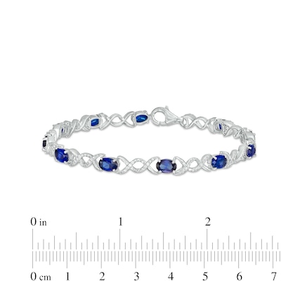 Oval Lab-Created Sapphire and 0.18 CT. T.W. Diamond Infinity Ribbon Link Line Bracelet in Sterling Silver – 7.5