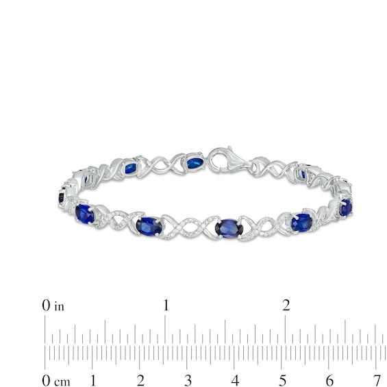 Oval Lab-Created Sapphire and 0.18 CT. T.W. Diamond Infinity Ribbon Link Line Bracelet in Sterling Silver – 7.5