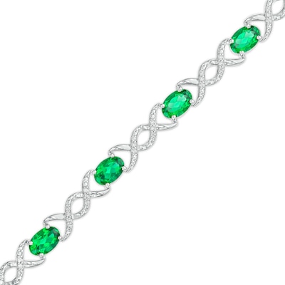 Oval Lab-Created Emerald and 0.18 CT. T.W. Diamond Infinity Ribbon Link Line Bracelet in Sterling Silver – 7.5"