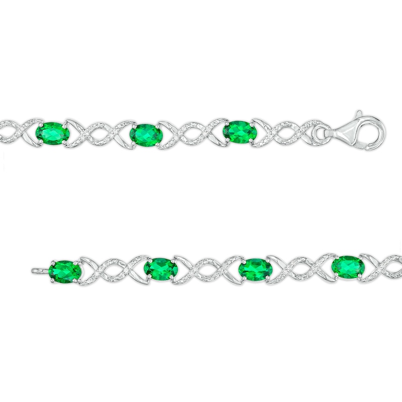 Oval Lab-Created Emerald and 0.18 CT. T.W. Diamond Infinity Ribbon Link Line Bracelet in Sterling Silver – 7.5"