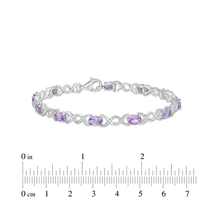 Oval Lab-Created Alexandrite and 0.18 CT. T.W. Diamond Infinity Ribbon Link Line Bracelet in Sterling Silver – 7.5"