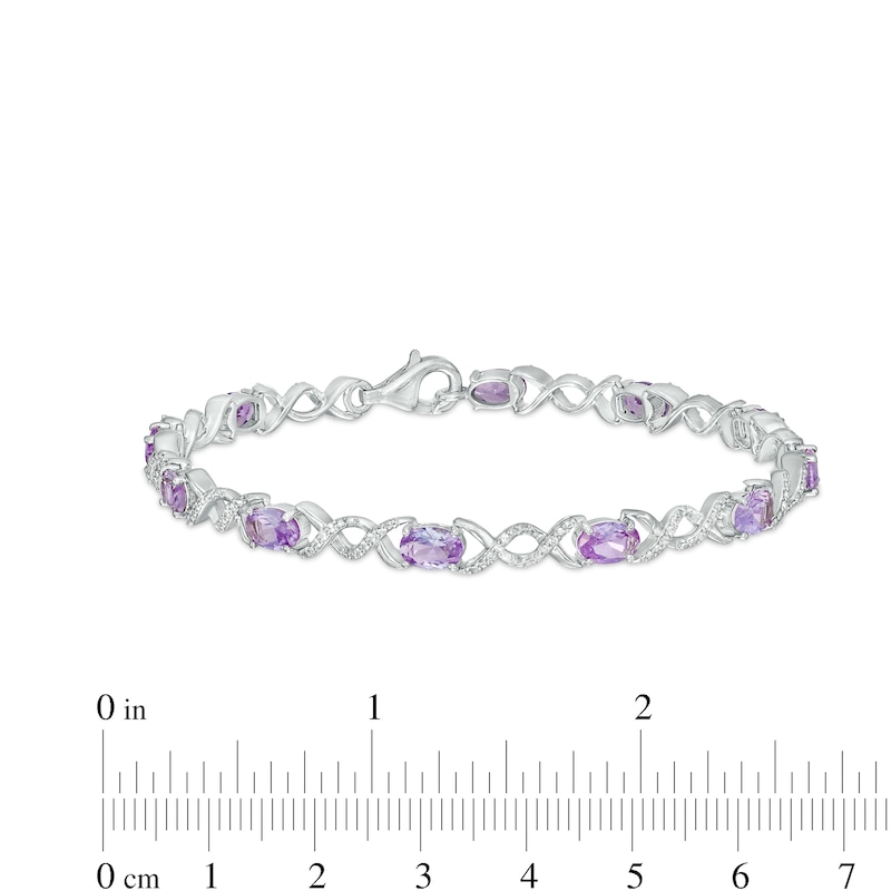 Oval Lab-Created Alexandrite and 0.18 CT. T.W. Diamond Infinity Ribbon Link Line Bracelet in Sterling Silver – 7.5"