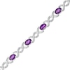 Thumbnail Image 0 of Oval Amethyst and 0.18 CT. T.W. Diamond Infinity Ribbon Link Line Bracelet in Sterling Silver – 7.5"