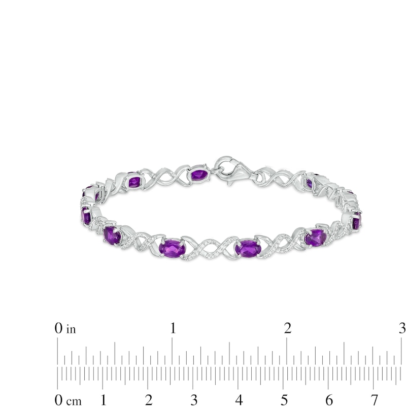 Oval Amethyst and 0.18 CT. T.W. Diamond Infinity Ribbon Link Line Bracelet in Sterling Silver – 7.5"