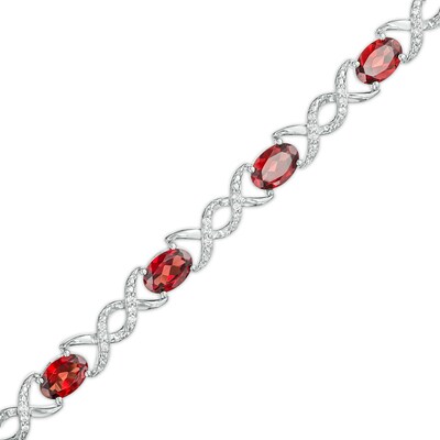 Oval Garnet and 0.18 CT. T.W. Diamond Infinity Ribbon Link Line Bracelet in Sterling Silver – 7.5"