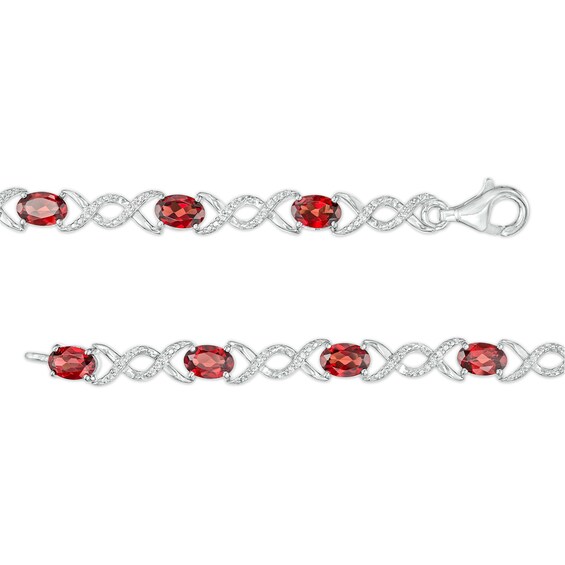 Oval Garnet and 0.18 CT. T.W. Diamond Infinity Ribbon Link Line Bracelet in Sterling Silver – 7.5"