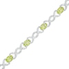Thumbnail Image 0 of Oval Peridot and 0.18 CT. T.W. Diamond Infinity Ribbon Link Line Bracelet in Sterling Silver – 7.5"