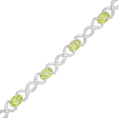 Oval Peridot and 0.18 CT. T.W. Diamond Infinity Ribbon Link Line Bracelet in Sterling Silver – 7.5"