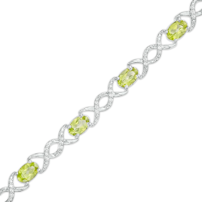 Oval Peridot and 0.18 CT. T.W. Diamond Infinity Ribbon Link Line Bracelet in Sterling Silver – 7.5"|Peoples Jewellers