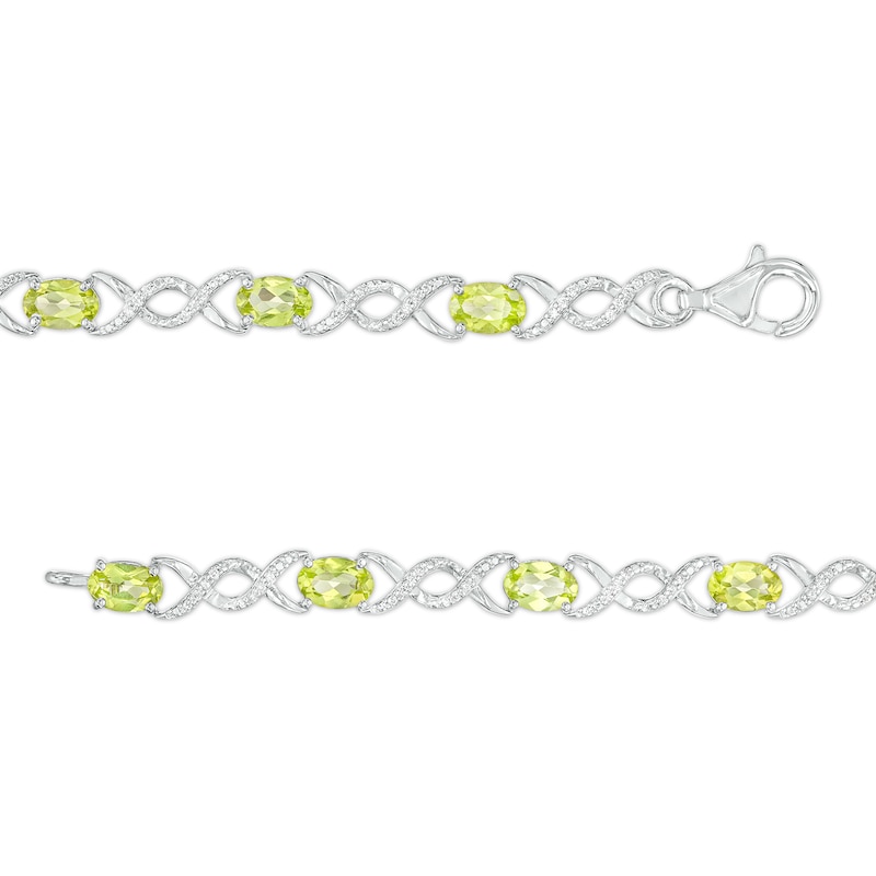 Oval Peridot and 0.18 CT. T.W. Diamond Infinity Ribbon Link Line Bracelet in Sterling Silver – 7.5"