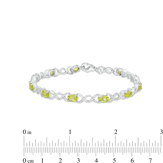 Oval Peridot and 0.18 CT. T.W. Diamond Infinity Ribbon Link Line Bracelet in Sterling Silver – 7.5"