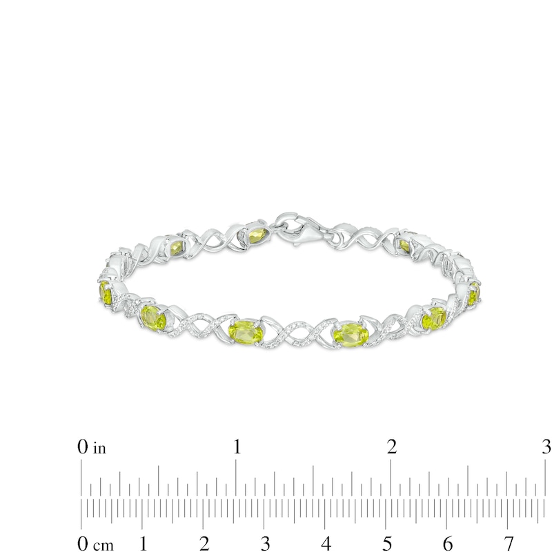 Oval Peridot and 0.18 CT. T.W. Diamond Infinity Ribbon Link Line Bracelet in Sterling Silver – 7.5"