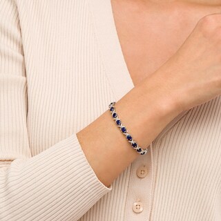 4.5mm Blue Lab-Created Sapphire and 0.14 CT. T.W. Diamond Alternating "XO" Line Bracelet in Sterling Silver – 7.5"