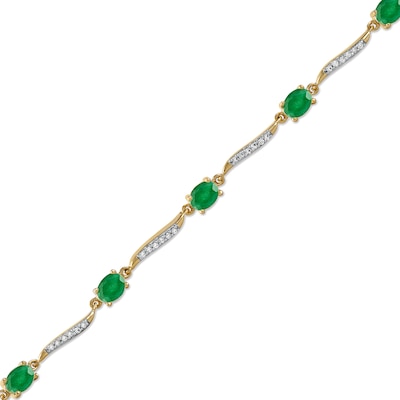 Oval Emerald and 0.16 CT. T.W. Diamond Wave Link Alternating Line Bracelet in 14K Gold – 7.25"