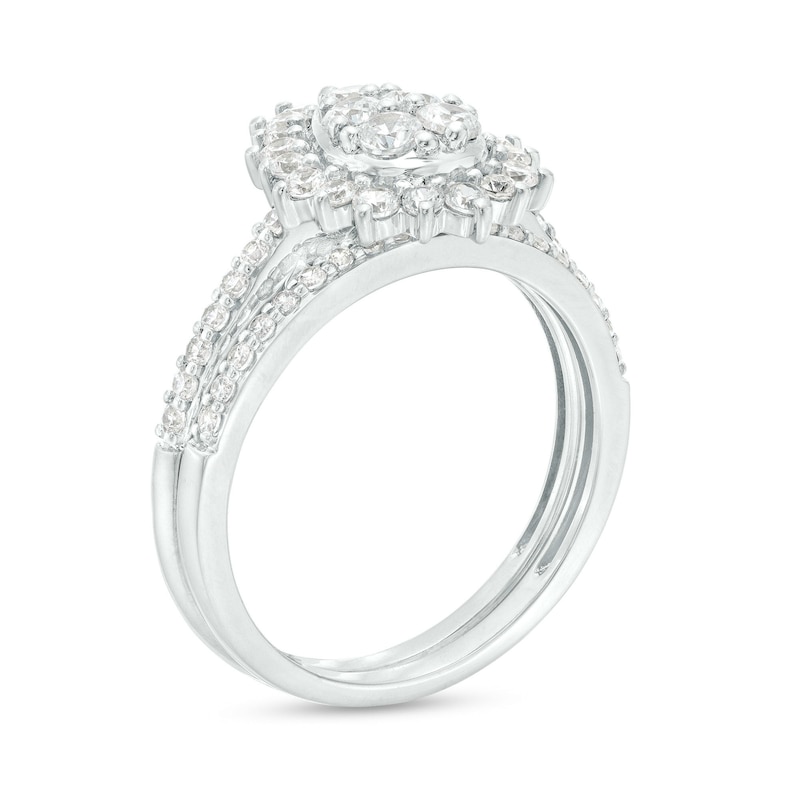 0.95 CT. T.W. Pear-Shaped Multi-Diamond Flower Frame Bridal Set in 10K White Gold (J/I3)