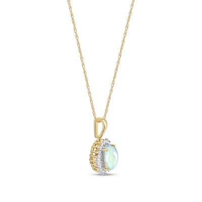 Oval Opal and 0.115 CT. T.W. Baguette and Round Diamond Starburst Frame Pendant in 10K Gold