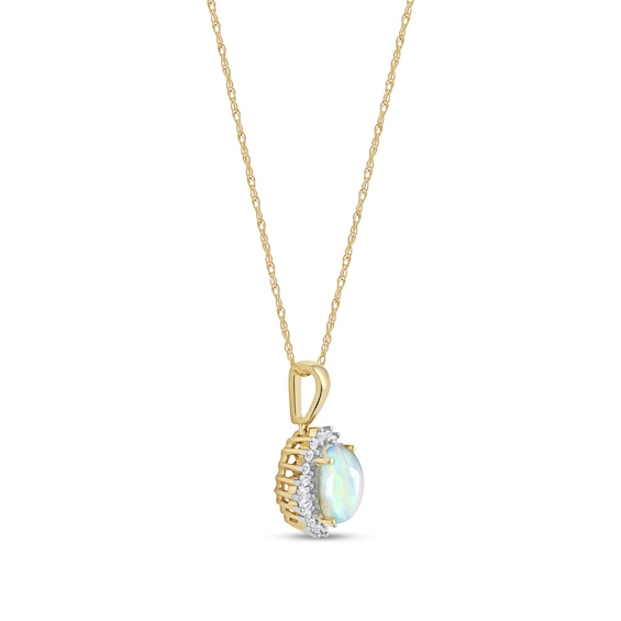 Oval Opal and 0.115 CT. T.W. Baguette and Round Diamond Starburst Frame Pendant in 10K Gold