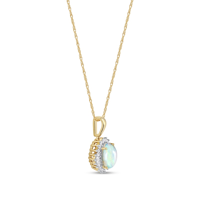 Oval Opal and 0.115 CT. T.W. Baguette and Round Diamond Starburst Frame Pendant in 10K Gold