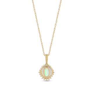 Oval Opal and 0.115 CT. T.W. Baguette and Round Diamond Starburst Frame Pendant in 10K Gold