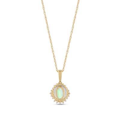 Oval Opal and 0.115 CT. T.W. Baguette and Round Diamond Starburst Frame Pendant in 10K Gold