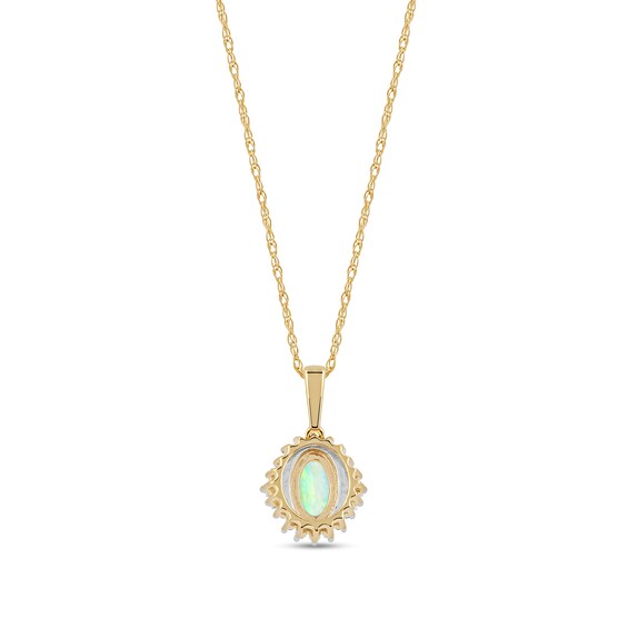 Oval Opal and 0.115 CT. T.W. Baguette and Round Diamond Starburst Frame Pendant in 10K Gold