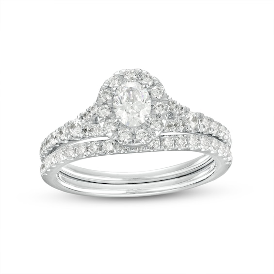 0.95 CT. T.W. Oval Diamond Frame Bridal Set in 14K White Gold (I/I1)