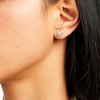 Thumbnail Image 1 of Circle of Gratitude® Collection 0.12 CT. T.W. Diamond Polished Braided Frame Stud Earrings in 10K Gold