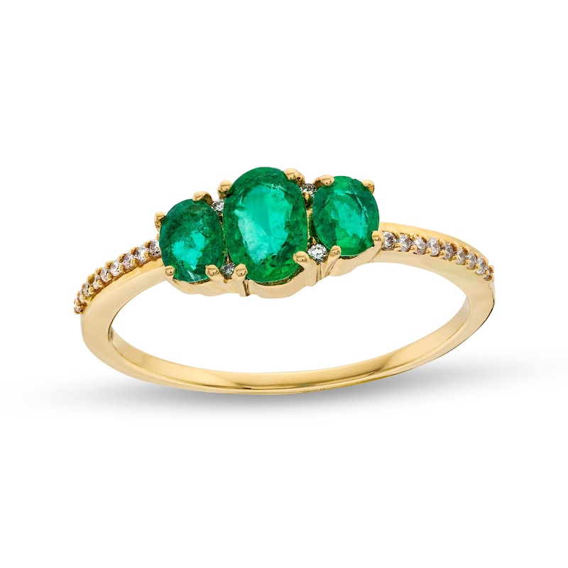 Oval Emerald and 0.05 CT. T.W. Diamond Three Stone Ring in 10K Gold
