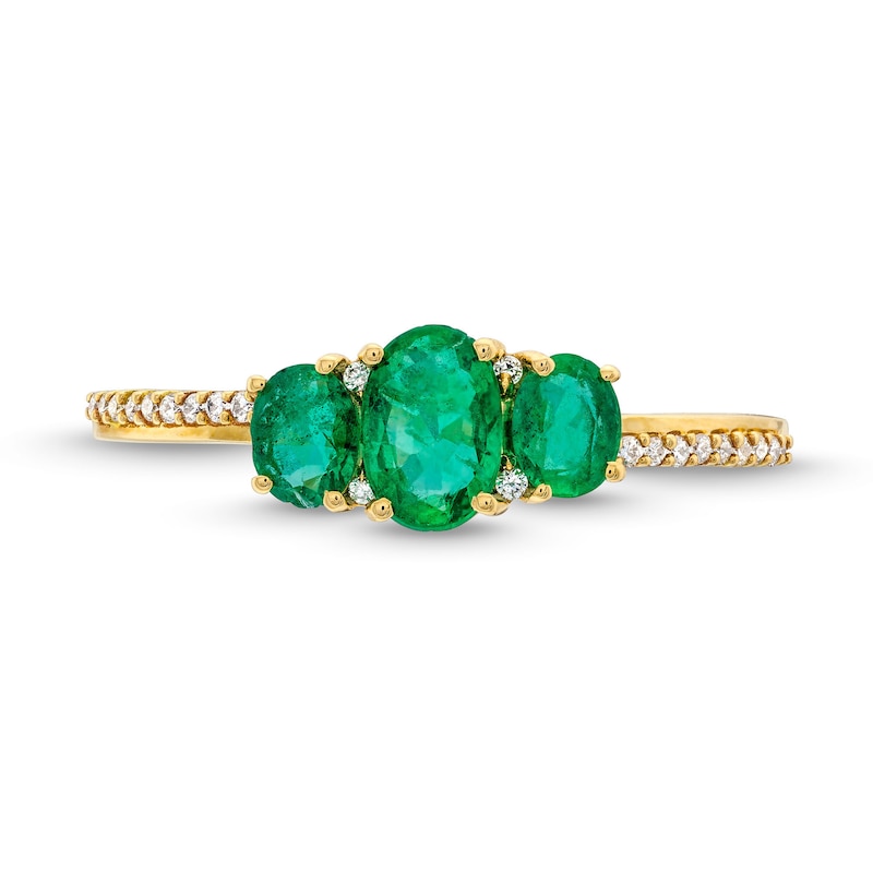 Oval Emerald and 0.05 CT. T.W. Diamond Three Stone Ring in 10K Gold
