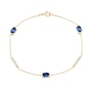 Thumbnail Image 0 of Oval Blue Lab-Created Sapphire and 0.18 CT. T.W. Certified Lab-Created Diamond Station Bracelet in 10K Gold - 7.25”