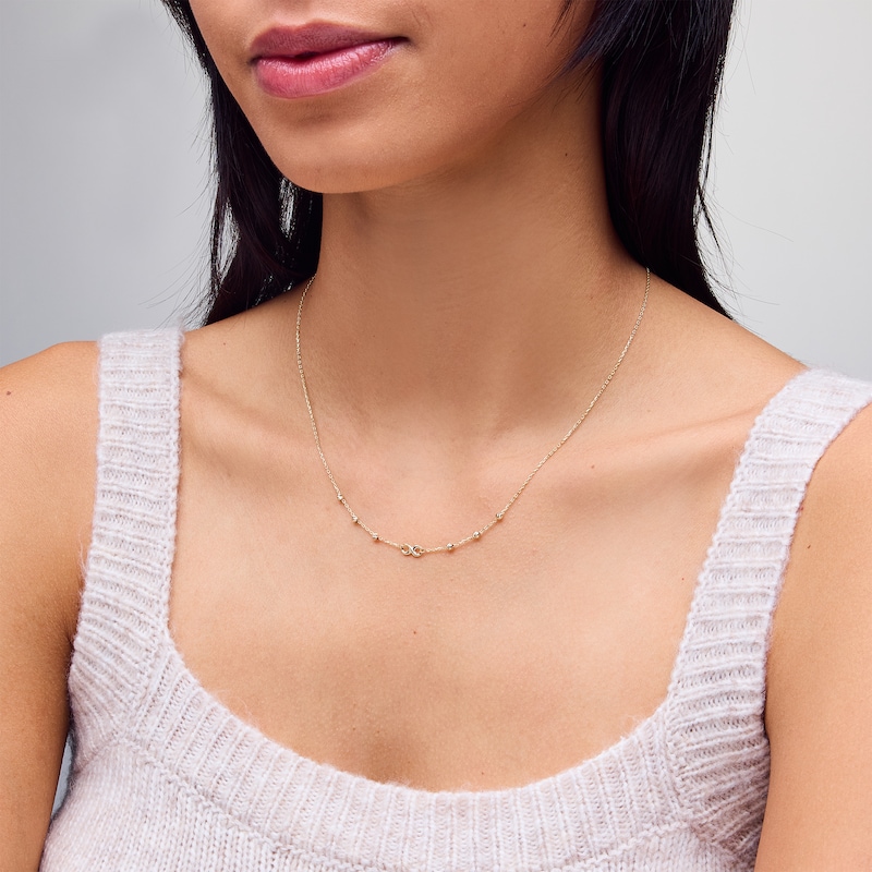 Infinity and Diamond-Cut Bead Station Necklace in 10K Gold