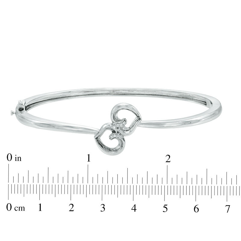 Previously Owned -  Diamond Accent Embracing Hearts Bangle in Sterling Silver