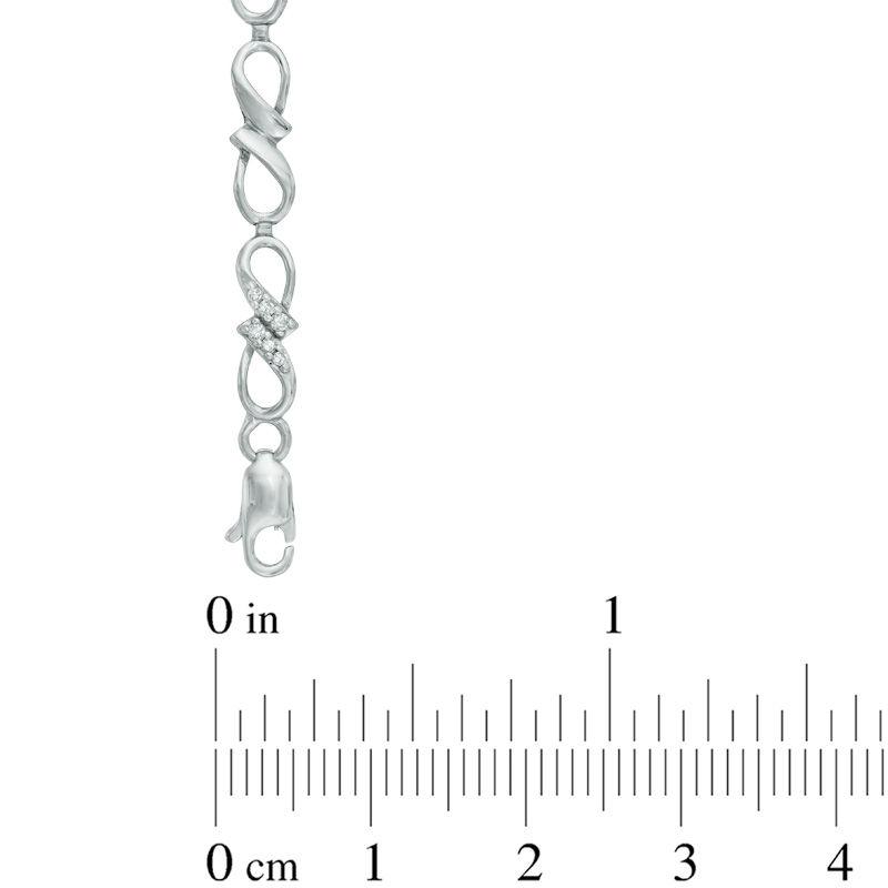 Previously Owned - 0.10 CT. T.W. Diamond Infinity Ribbon Link Bracelet in Sterling Silver - 7.25"