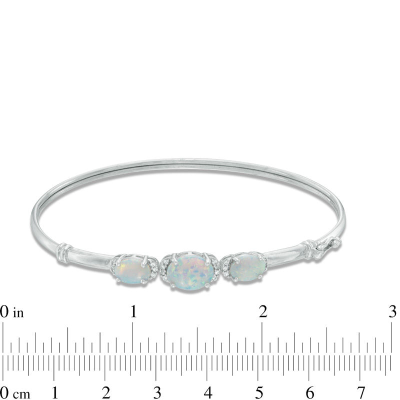 Previously Owned - Oval Lab-Created Opal and White Sapphire Three Stone Bangle in Sterling Silver