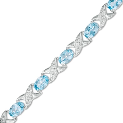 Previously Owned - Sideways Oval Swiss Blue Topaz and Diamond Accent "XO" Bracelet in Sterling Silver - 7.25"