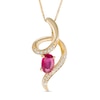 Previously Owned - Oval Ruby and Diamond Accent Looping Ribbon Pendant in 10K Gold