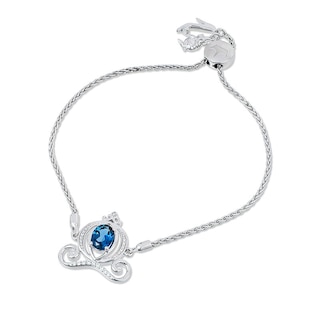 Previously Owned - Enchanted Disney Cinderella Oval Blue Topaz and 0.085 CT. T.W. Diamond Carriage Bolo Bracelet