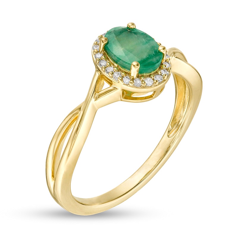 Previously Owned - Oval Emerald and 0.08 CT. T.W. Diamond Frame Twist Shank Ring in 10K Gold