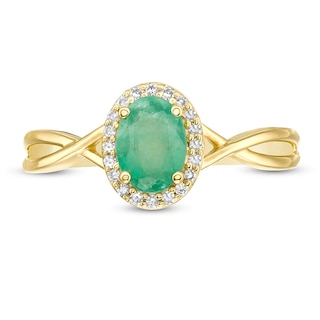 Previously Owned - Oval Emerald and 0.08 CT. T.W. Diamond Frame Twist Shank Ring in 10K Gold