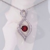 Unstoppable Love™ 4.5mm Garnet and 0.11 CT. T.W. Diamond Infinity Flame Pendant in Sterling Silver