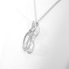 0.066 CT. T.W. Diamond Double Offset Hearts with Square Knot Pendant in Sterling Silver